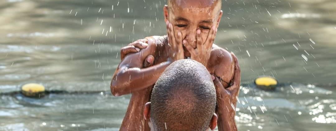 Boy getting baptized in the Jordan River | Balsam Tours